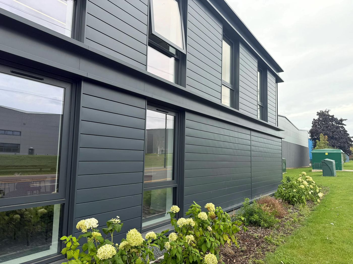 Dark grey cladding on a business park office after cleaning