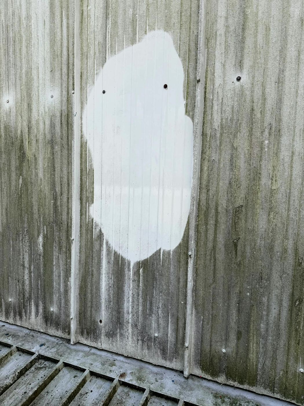 Test patch cleaned on stained cladding, showing the original colour underneath