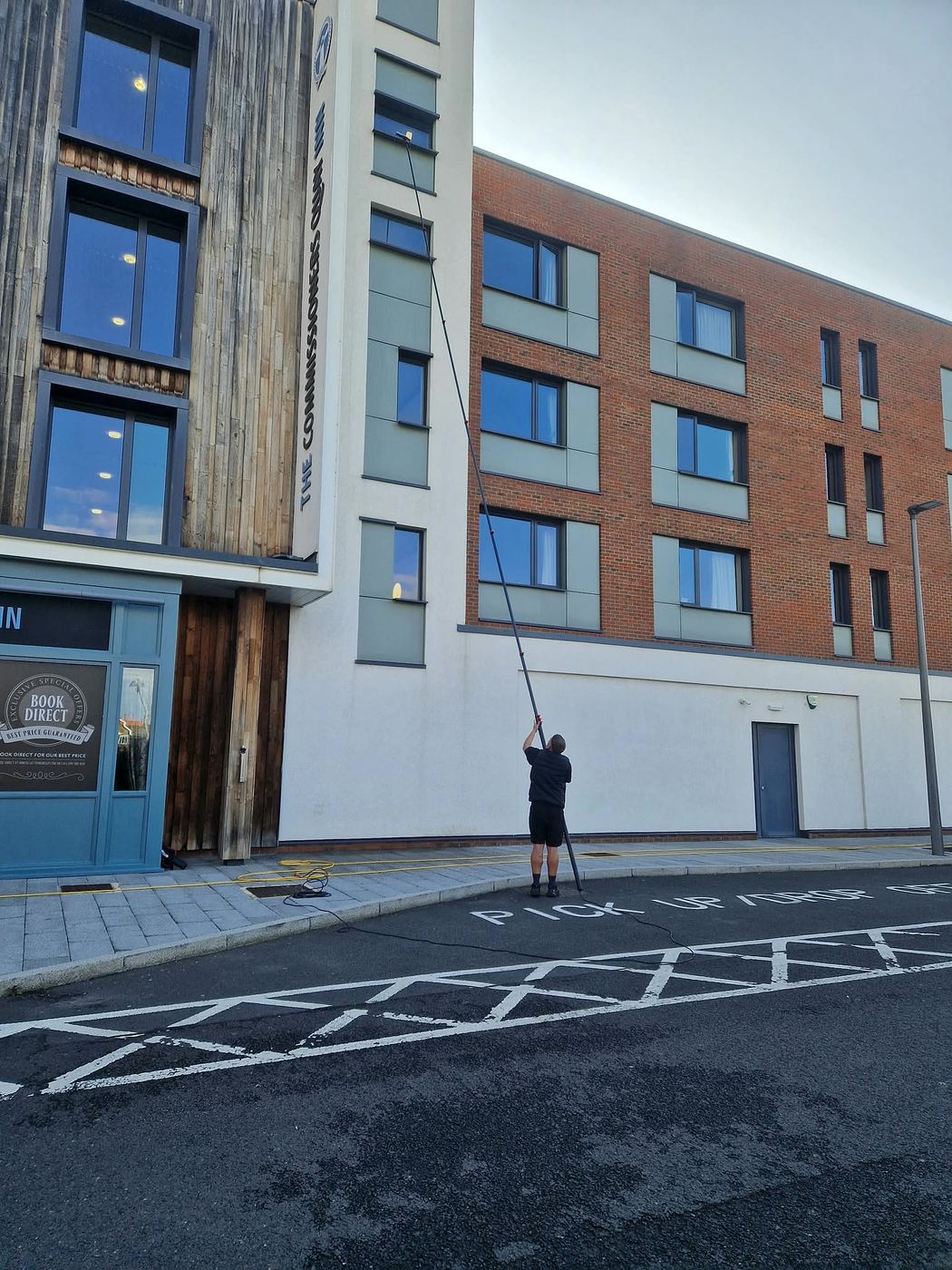 Cleaning upper-floor windows at The Commissioners Quay Inn