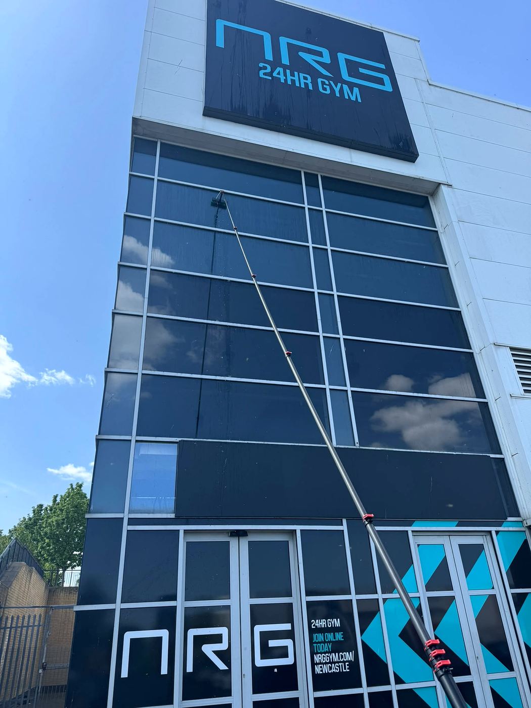Reach-and-wash pole cleaning high-level glazing at NRG 24hr Gym, Newcastle